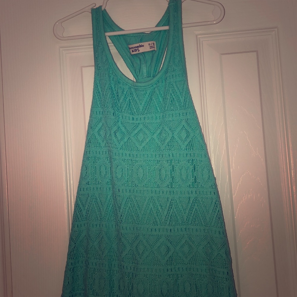 teal designed shirt that looks like wear in summer